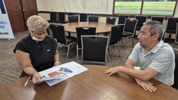 John Ramoska, associate dean of enrollment management at SUNY Fulton Montgomery, discusses enrollment options with Judyane Allmen, a prospective nursing student.