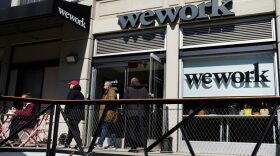 People walk out of the co-working space WeWork in the Williamsburg neighborhood in Brooklyn in New York City.