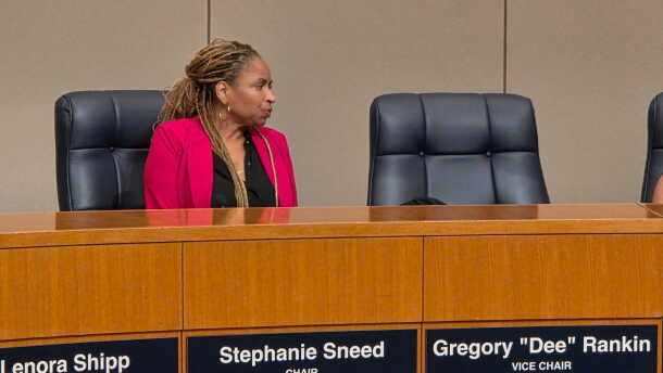 Woman at dais in pink jacket