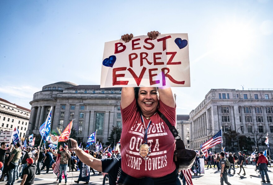 A Trump supporter holds her sign before she marches.