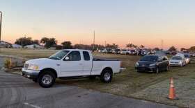 Vehicles arrived before 5 a.m. Wednesday at a mobile food drop in Groveland. Photo: Joe Bynes