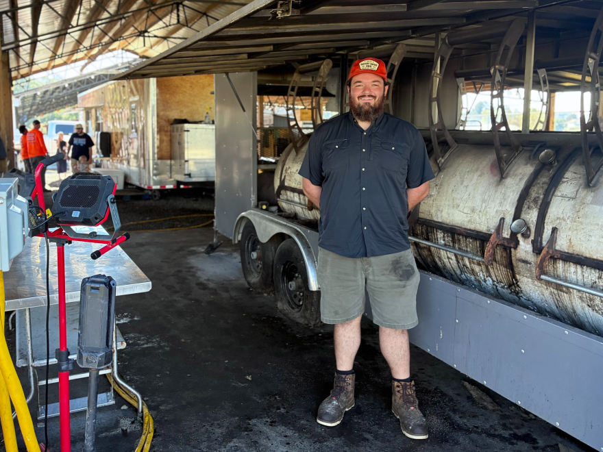 Nick Dampf stands in front of the barrel-shaped smokers at his Michelin award-winning, Texas-style barbecue food truck in Cary, N.C.