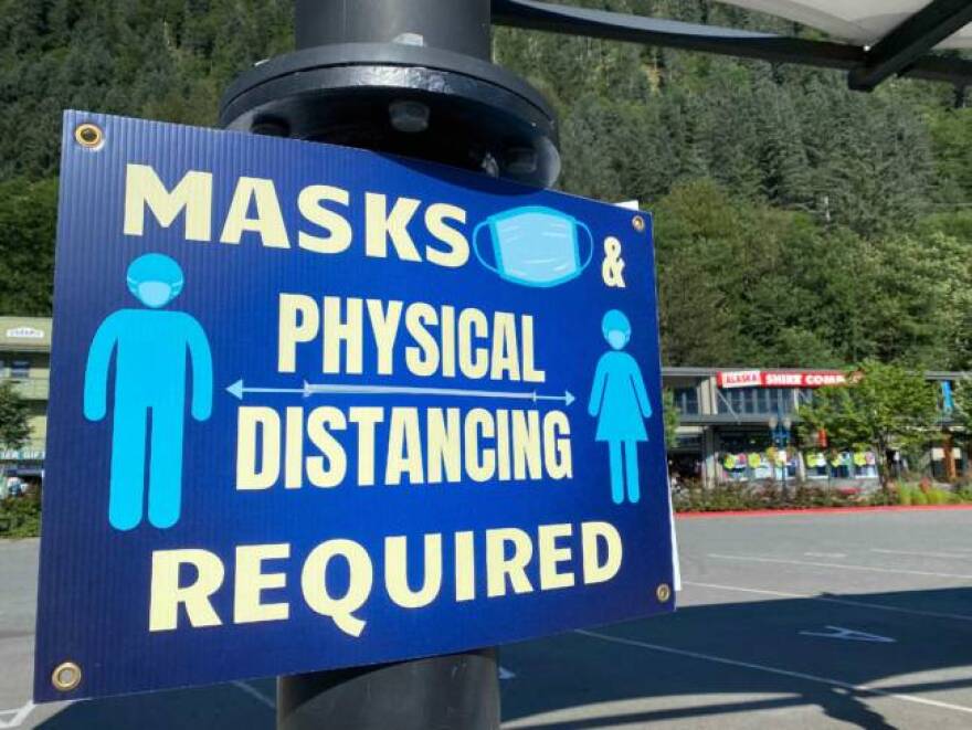 A sign in Juneau reminding people about mask and physical distancing requirements. (Bridget Dowd/KTOO)