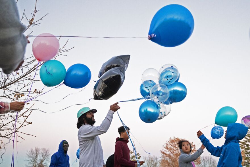 Christian Lewis, Andre Roland’s younger brother, looks up art the sky before releasing balloons in Roland’s memory on Friday, Nov. 17, 2023 at Columbia Memorial Cemetery in Columbia. “This one's for you, ‘Dre,” said Lewis.