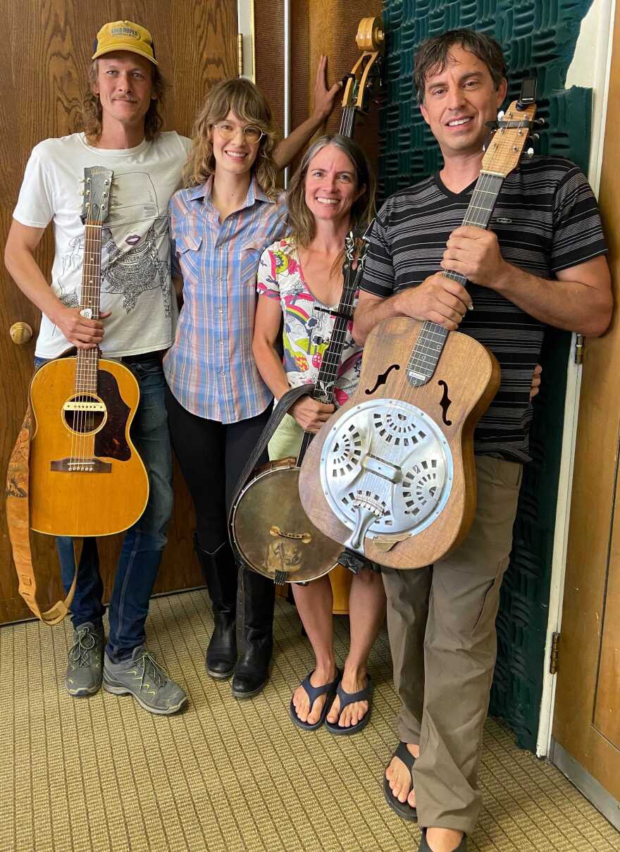 Lovers Leap, Musicians Joel Timmons, Shelby Means, Mary Lucey, and Billy Cardine holding their instruments