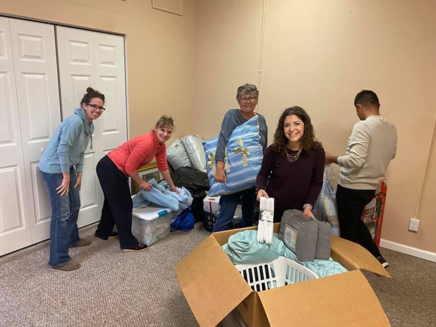 Community members set up an apartment with donated items for an Afghan family.
