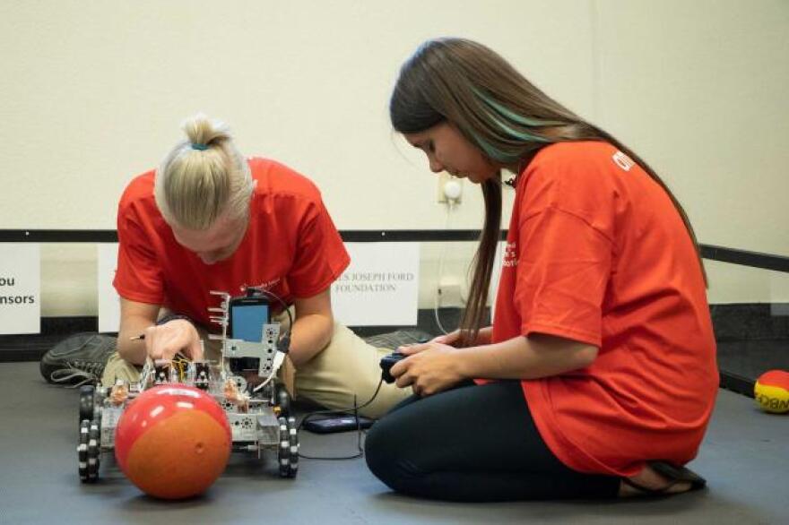 Carly Lamb, right, says she wants to share what she has learned through the Nevada Blind Children's Foundation by serving as a counselor to other visually impaired young people. She and another foundation client check out the robotics equipment at the group’s new learning center, which opened in Henderson this week.