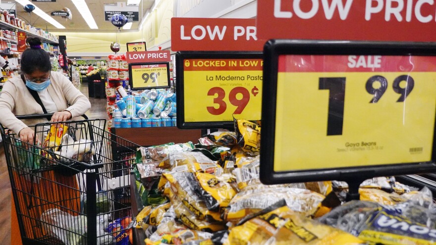 A shopper fills her cart in a grocery store in Los Angeles. Inflation has made the cost of groceries jump, but some prices have started to level off.