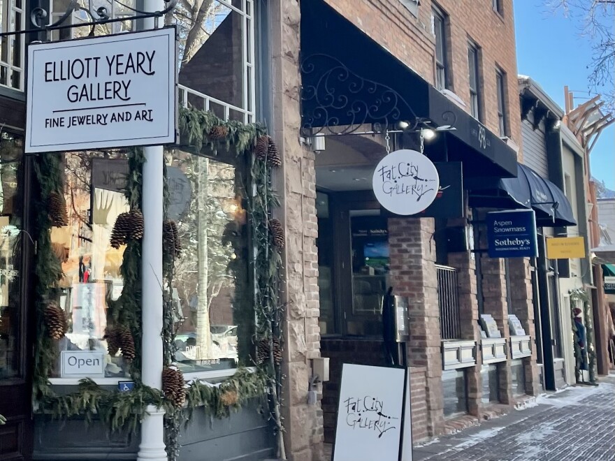 A sandwich board and hanging sign mark the entrance to the new Fat City Gallery location on the East Hyman Avenue pedestrian mall in downtown Aspen.