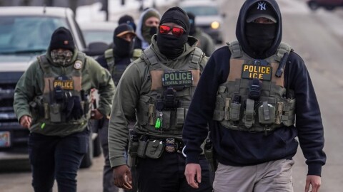 Federal agents walk down a street while conducting immigration enforcement operations in Minneapolis, Feb. 5, 2026. (AP Photo/Ryan Murphy, File)
