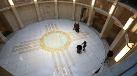 People walk under the state Capitol rotunda during the annual legislative session on Wednesday, Feb. 2, 2022, in Santa Fe, New Mexico. The 60-day meeting of the Legislature began hashing out the state budget, and consider sweeping proposals on education, medicare, and policing last month. (AP Photo/Cedar Attanasio)
