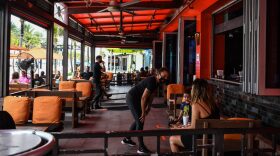 People eat sitting outside of a restaurant on Fort Lauderdale Beach Boulevard in Fort Lauderdale, Florida.