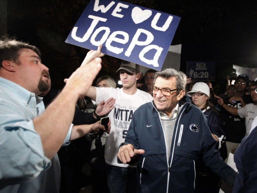 Scott Paterno, left, greeted his father — Penn State football coach Joe Paterno — as the coach arrived at his home, Tuesday evening in State College, Pa. Hundreds of students had gathered to show support for the coach.