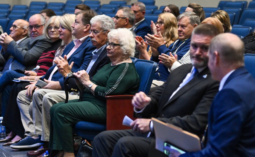 Members of the Kotlowski family and their friends listen to speakers at Wilkes-Barre Area High School on Friday.