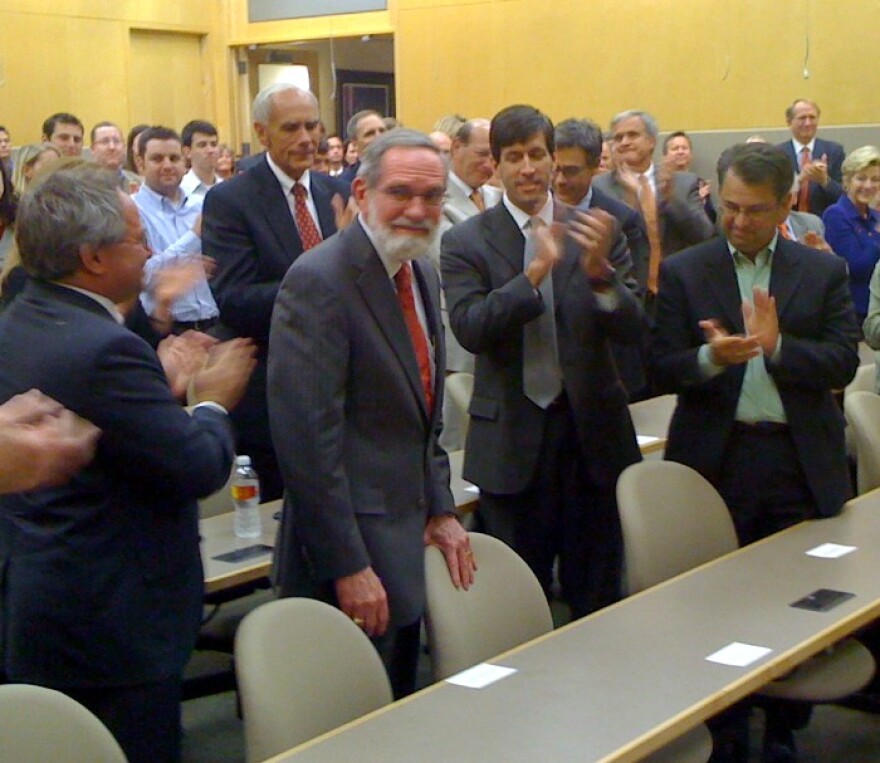 Tulsa Attorney Fred Dorwart (in red tie)is surprised by the chair named in his honor.