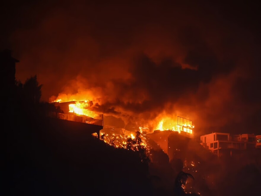 The Palisades Fire burns houses in the hill next to the Getty Villa Wednesday, Jan. 8, 2025 in Pacific Palisades, Calif.