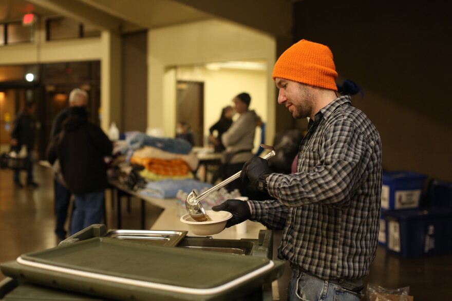 Man ladling soup into bowl.