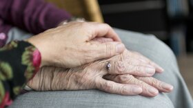 Image of seniors holding hands
