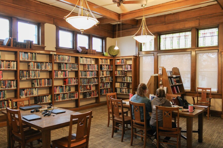 Anastasia (left) and Alexa Oller (right) sit in the library's main section working on some online school work. The Oller family are fairly regular patrons of the library.