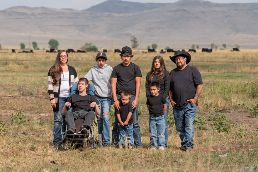 Nicole Silva, left, poses with her family in Sanford, Colorado. Silva had her wages garnished for an ambulance bill after her daughter needed urgent medical care. According to a KFF Health News analysis, Colorado courts allow debt collectors to garnish people’s wages for unpaid medical bills in roughly 14,000 cases a year.