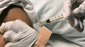 A sickle cell disease patient is given an injection for pain relief by a nurse