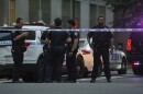 A New York Police officers gather at the scene on 52nd Street outside a Manhattan office building where two people were shot, including a New York police officer, Monday, July 28, 2025, in New York.