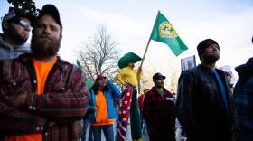 A man on stilts wears state of Jefferson regalia at a Timber Unity rally in front of the Oregon Capitol in Salem, Ore., Thursday, Feb. 6, 2020. (Bradley W. Parks/OPB)