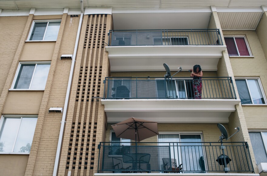 McClellan stands on her balcony, watching her kids play. "I have a roof over my head," she says. "Now I can focus on getting a job and ... moving forward in life."