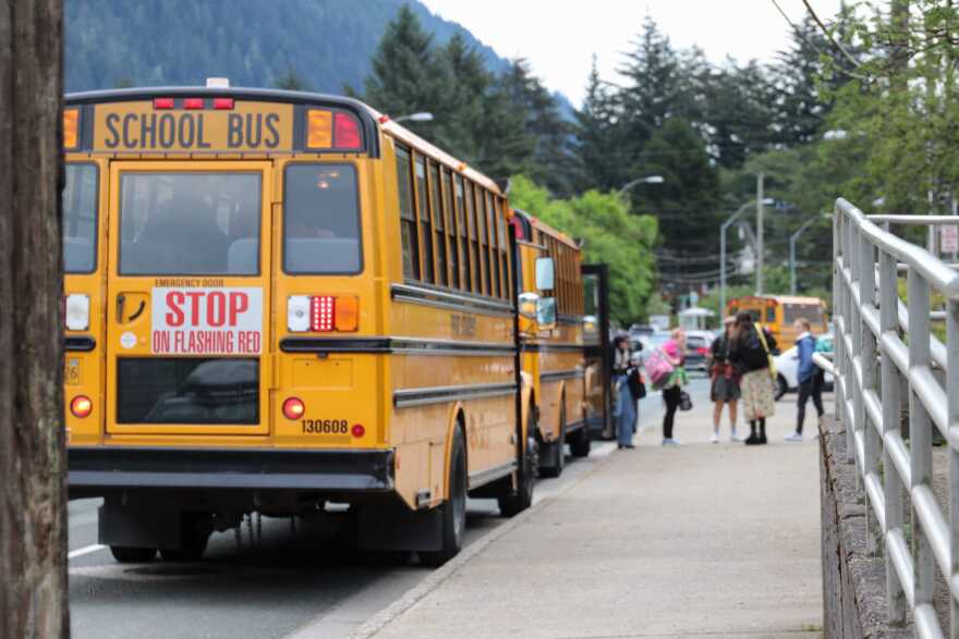 Students exit a school bus outside of Juneau-Douglas High School: Yada.aat Kalé on Aug. 15, 2025