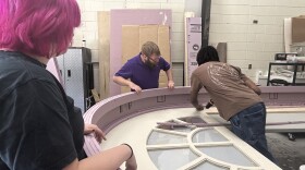 (From left to right) Virginia Peninsula Community College student Salem Trichoe, Theater Manager David Garrett and student Dorin Watson craft a set piece on June 24, 2026, for the "America Made in Virginia: 250 Years Together" July 4th program at Colonial Williamsburg.