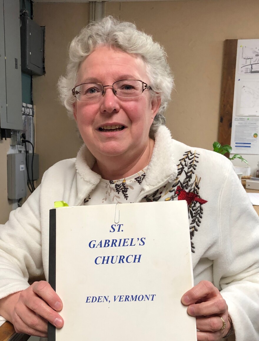 Tracey Morin holds a yearbook of memories from St. Gabriel's Church.