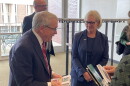 Ohio Governor Mike DeWine, left, receives notecards designed by students from Cleveland State University President Laura Bloomberg after her State of the University speech on Oct. 14.