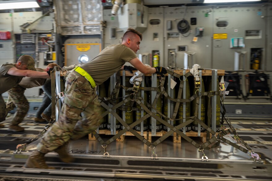 Troops at Dover Air Force Base in Delaware load pallets of ammunition onto an aircraft bound for Ukraine Aug. 9, 2022.