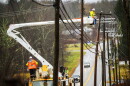 FILE: An Eversource crew on Route 44 in Bolton, Ct. repairs damaged power lines, December 18, 2023, as strong winds and heavy rain across Connecticut left more that 75,000 people without power, closed schools and snarled traffic.