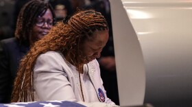 Chantemekki Fortson, left, the mother of slain airman Roger Fortson stands at his casket during his funeral at New Birth Missionary Baptist Church, Friday, May 17, 2024, near Atlanta. (AP Photo/Brynn Anderson)