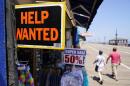 People walk past a help wanted sign in front of a souvenir shop along the boardwalk, in Ocean City, New Jersey. (Matt Slocum/AP)