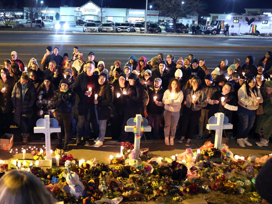 People visit a makeshift memorial near the Club Q nightclub in Colorado Springs, Colo.