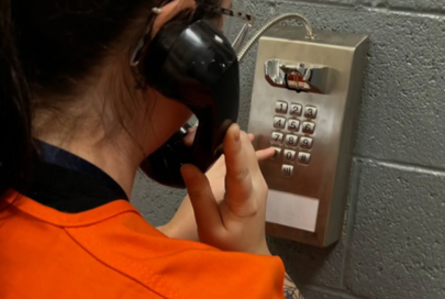 An Oklahoma County Detention Center detainee uses a jail phone.