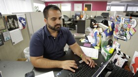 Ricardo Negron works at his office in Orlando, Fla., where he runs a community center. Negron, who trained as a lawyer in Puerto Rico, said he doesn't have the time or the money to take off three months to study for the Florida bar exam to practice law. (AP Photo/John Raoux)