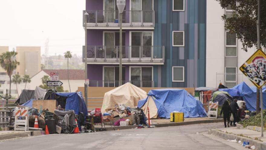Tents are set up along a freeway in a homeless encampment, May 12, 2025, in Los Angeles. (Damian Dovarganes/AP)