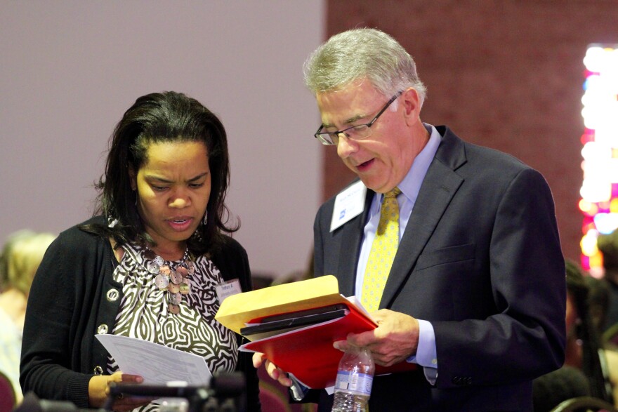 Ferguson Commission executive director Bethany Johnson-Javois and co-chairman Rich McClure examine the agenda before the last meeting of the Ferguson Commission.