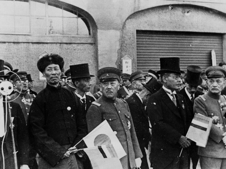 High officials of Manchukuo, the puppet state set up by Japan in Manchuria, gather at the pier to see the Kangde emperor depart for Tokyo, circa 1935.