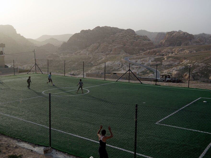 Boys play soccer on a field in the Bedouin village of Um Sayhoun, near Petra.