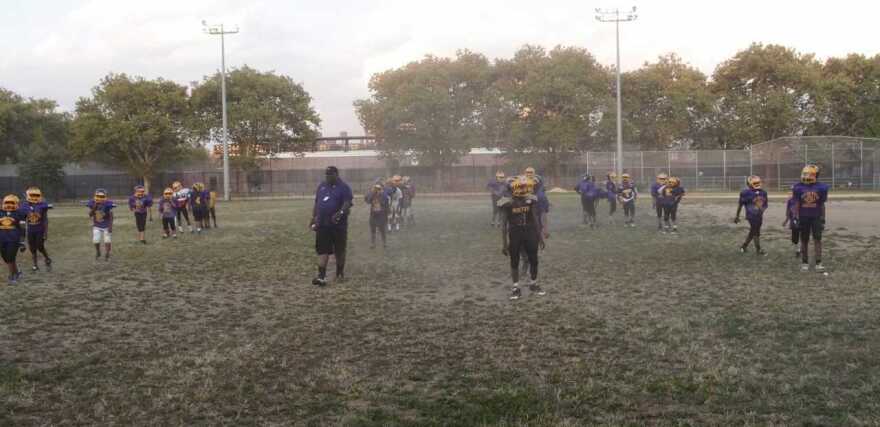 Boys on the Mo Better Jaguars youth football team line up for warm ups during practice in September 2014.