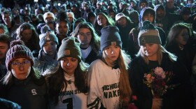 Mourners attend a vigil at The Rock on the grounds of Michigan State University in East Lansing, Mich., Wednesday, Feb. 15, 2023. Alexandria Verner, Brian Fraser and Arielle Anderson were killed and several other students remain in critical condition after a gunman opened fire on the campus of Michigan State University Monday night. (AP Photo/Paul Sancya)