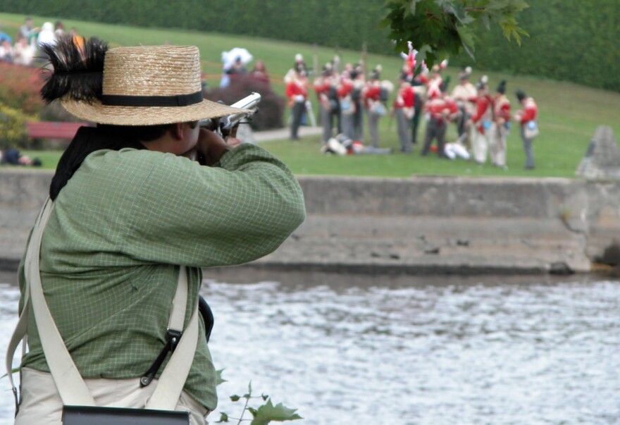 A reenactor takes aim during a 2013 Battle of Plattsburgh reenactment