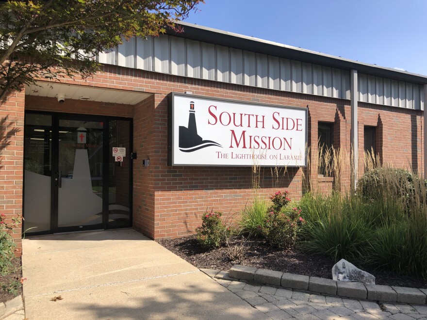 A sign mounted on the wall marks the main entrance to the South Side Mission building on Laramie Street in Peoria.