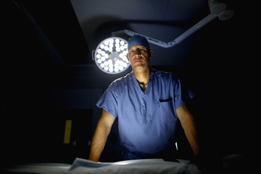 U.S. Air Force Lt. Col. Chance Henderson, an orthopedic surgeon, stands in the operating theater of the military hospital at Bagram Airfield in Afghanistan. Henderson has saved the leg of a 6-year-old Afghan girl who was shot during a firefight between U.S. and Afghan forces and the Taliban.