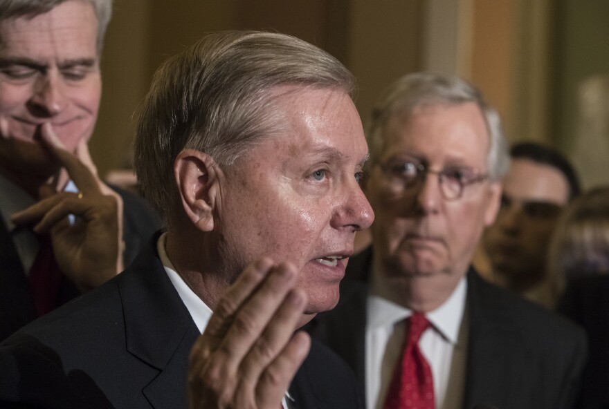 Sen. Lindsay Graham, R-S.C., flanked by Sen. Bill Cassidy, R-La., left, and Senate Majority Leader Mitch McConnell, R-Ky., right, speaks to reporters as they faced assured defeat on the Graham-Cassidy bill, the GOP's latest attempt to repeal the Obama health care law, at the Capitol in Washington, Tuesday, Sept. 26, 2017. The decision marked the latest defeat on the issue for President Donald Trump and Senate Majority Leader Mitch McConnell in the Republican-controlled Congress. (AP Photo/J. Scott Applewhite)