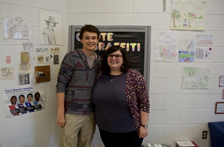 Student Ray Starn and teacher Mira Rahili stand in a classroom.